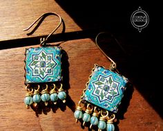 Dreaming of hand tiled Islamic Mosques? These earrings are grand handmade reproductions of beautiful Islamic tiles. A larger tile for a bolder statement. Ready to ship in crafty packaging. The handmade tile measures 2cm by 2cm square, and sits in an antique bronze lace edge setting. Beautiful frosty turquoise melon beads dangle in delight! The drop length of the earring is approximately 5.6 cm ensuring the earring will not go unnoticed! I recreate and hand make vintage Islamic tile patterns in m Handmade Bohemian Square Earrings, Handmade Square Bohemian Earrings, Handmade Traditional Rectangular Earrings, Traditional Handmade Rectangular Earrings, Handmade Square Turquoise Jewelry, Islamic Pottery, Islamic Tiles, Pottery Design, Handmade Tile