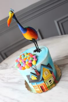 a colorful bird figurine sitting on top of a bed