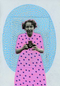 a woman holding a camera in front of a blue and pink circle with dots on it