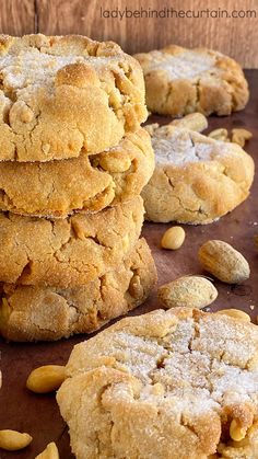 several cookies stacked on top of each other with nuts scattered around them in the foreground