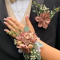 the bride and groom are wearing matching boutonnieres