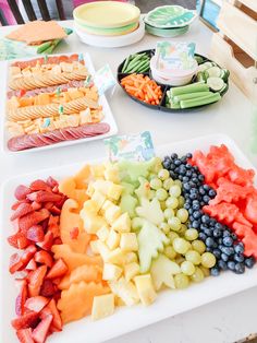 there are many different types of fruits on the table and one is cut up to eat