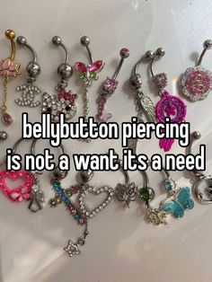 there are many different types of bellybutton piercings on the table, and one is not a want it's a need