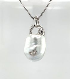 This exquisite, eye-catching necklace features an impressive South Sea white baroque pearl with gorgeous luster, set in 18k white gold with sparkling diamonds! The spectacular gem has lovely rainbow pearlescence and measures 22 x 18mm. Its elegant and uniquely dimensional shape is complimented by a sophisticated design and gives the pendant a timeless, yet organic feel that is perfect for both everyday and special occasion wear! Pendant measures approximately 1.5" long. 22 inch, 14k white gold c Luxury Silver Necklace With Pearl Drop, Luxury Silver Pearl Drop Necklace, Luxury Teardrop Pearl Necklace, Luxury Silver Pearl Pendant Necklace, Luxury Silver Pendant Pearl Necklace, Luxury Silver Baroque Pearl Necklace, Luxury High Luster White Pearl Necklace, Luxury Sterling Silver Pendant Pearl Necklace, Luxury Silver Pearl Necklace With Pendant