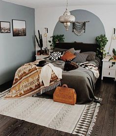 a bed room with a neatly made bed and pictures on the wall