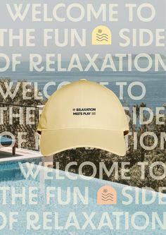 a yellow hat sitting on top of a swimming pool next to the ocean with words all over it