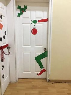 the door is decorated with christmas decorations and elf legs, nose, leggings