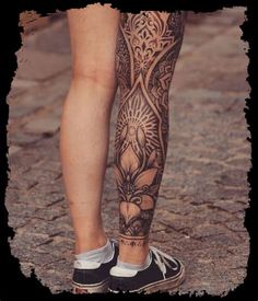 a person with tattoos on their legs and feet