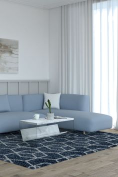 a living room with a blue sectional couch and coffee table