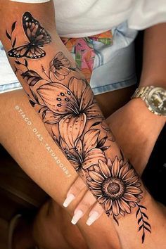 a woman's arm with flowers and butterflies on it