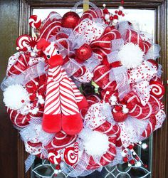 a red and white christmas wreath with candy canes