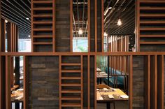 the interior of a restaurant with wooden walls and stairs leading up to an indoor dining area