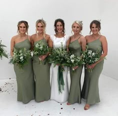 the bridesmaids are all dressed in green dresses