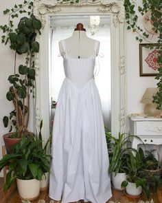 This lightweight cotton corset dress is perfect for summertime picnics, frolicking through flower fields, brunch dates, and even as a wedding dress for the cottagecore princess bride. The corseted bodice is lined with cotton coutil and boned with stainless steel. This dress has large pockets, making it practical as well as beautiful.  This dress can also be made in white duchess satin, which is a heavy, high quality, luxurious fabric perfect for a wedding dress.  The corseted bodice reduces your Cotton Dress With Fitted Bodice For Garden Party, Spring Wedding Corset Dress With Square Neck, Summer Wedding Dresses In Balletcore Style, Cotton Dress With Sweetheart Neckline For Garden Party, Vintage Summer Wedding Dress With Square Neck, Summer Wedding Corset Back Dress, Summer Balletcore Dress With Fitted Bodice, Summer Wedding Corset Dress With Square Neck, White Cotton Corset Dress With Corset Back