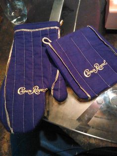 two purple oven mitts sitting on top of a metal pan