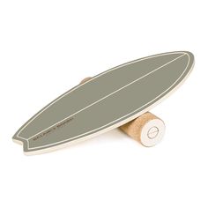 a wooden surfboard is standing upright against a white background and has a light green stripe on it