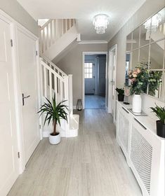 an instagram photo of a house with white walls and wood flooring in the hallway