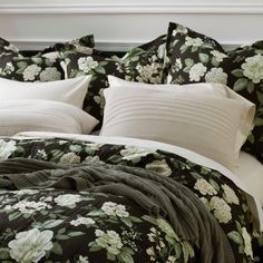 a bed with black and white flowers on it