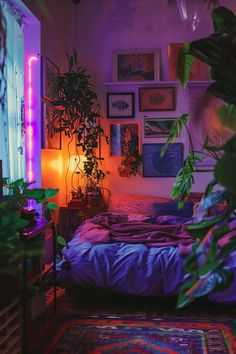 a bedroom with plants and pictures on the wall