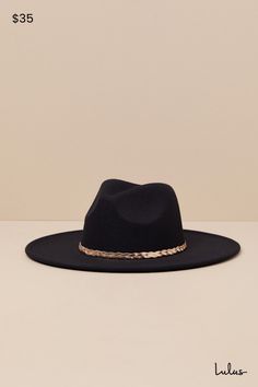 Western wear just got a little more chic, thanks to the Cowgirl Composure Black Felt Metal Band Western Hat! This iconic hat has a soft, felt composition that shapes the recognizable cowboy silhouette of a wide brim, a high collar, and a classic dipped crown. Gold-toned herringbone chain creates a chic braided band to complete the look. 3. 75" Soft Brim. 23" Interior Circumference. 90% Polyester, 10% Alloy. Imported. Lulus | Cowgirl Composure Black Felt Metal Band Western Hat. Chic Brimmed Felt Hat For Rodeo, Wide Brim Hat Bands For Fall Parties, Party Wide Brim Hat Bands For Fall, Fall Party Hat Bands With Wide Brim, Fall Party Felt Hat With Short Brim, Chic Felt Fedora For Rodeo, Chic Winter Felt Hat For Rodeo, Chic Fedora With Short Brim For Country Events, Western Style Party Hat For Fall