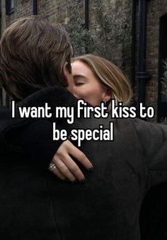 a man and woman kissing in front of a brick wall with the words i want my first kiss to be special