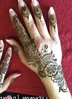 two hands with henna tattoos on them