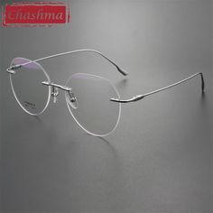 This pair of Chashma Ottica Unisex Rimless Flat Top Round Titanium Eyeglasses 96611 is a stylish and modern choice for both men and women. Crafted from high-quality titanium, these eyeglasses are durable and lightweight, ensuring a comfortable fit. The solid pattern design adds a touch of sophistication to these eyeglasses, making them suitable for any occasion. Whether you're at the office or out with friends, these glasses are sure to complement your look. These eyeglasses come with MR-3 Plast Spectacles For Women, Eyeglasses Men, Rimless Frames, Men Eyeglasses, Top Round, Flats Top, Watch Necklace