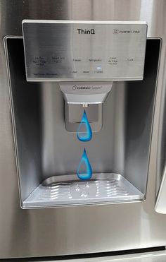 a water dispenser with blue liquid coming out of it