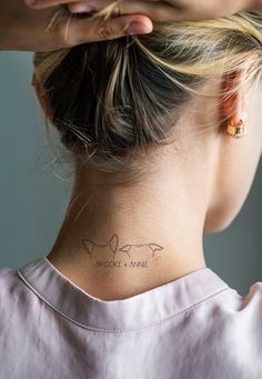 a woman with a small tattoo on her neck