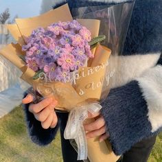 a person holding a bouquet of flowers in their hands