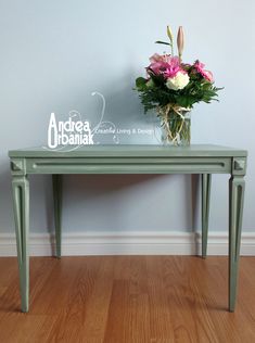 a vase with flowers sitting on top of a green table