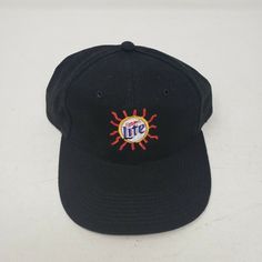 Vintage Miller Lite Beer Sunrays Logo Strapback Hat With A Spanish Slogan: Saborea Una Verdadera Cerveza Pilsner Which Translates: Savor A Real Pilsner Beer Men's One Size Fits Most New/Unworn No Manufacturer Warranty Implied Or Given Retro Black Baseball Cap With Embroidered Logo, Retro Black Dad Hat With Curved Brim, Miller Genuine Draft, Lite Beer, Pilsner Beer, Miller Lite, Draft Beer, Strapback Hats, Pilsner