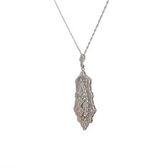 This Art Deco filigree pendant necklace is crafted in polished 14 karat white gold, reflecting the intricate artistry of the era. The pendant features three single-cut diamonds, each with SI1 clarity and H color grade, weighing .03 carats and measuring 1.25 mm. The diamonds are arranged to catch the light and add sparkle to the piece. The filigree detailing and milgrain accents enhance its vintage charm. This necklace is ideal for those who appreciate antique jewelry or fine craftsmanship, making it a timeless addition to any collection. It can be worn alone or layered for a unique statement. Exquisite Platinum Pendant Jewelry, Formal Art Deco Diamond Necklace With Accents, Art Deco Silver Necklace With Single Cut Diamonds, Art Deco Single Cut Diamond Pendant Jewelry, Art Deco Pendant Jewelry With Single Cut Diamonds, Art Deco Single Cut Diamond Pendant, Art Deco Style Single Cut Diamond Pendant, Formal Art Deco Necklaces With Single Cut Diamonds, Rectangular Diamond Cut Diamond Necklace