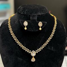 Description: This yellow gold color CZ necklace and matching earrings are lightweight and made with the highest quality craftsmanship. They are a stunning addition to any outfit and will make a perfect gift for any occasion. Inter Changeable   pear shape earrings and pendant with different colors Features: Crystal stones Lightweight and elegant Can be paired with any dress, kurti, or saree Material: Pearl dropping Cubic Zirconia (CZ) Stones Solitaire Necklace Ready to ship from California Free U Gold Jewelry Sets With Matching Earrings For Celebration, Festive Yellow Gold Jewelry Sets With Matching Earrings, Gold Diamond Jewelry Sets With Earrings, Gold Diamond Jewelry Set With Matching Earrings, Gold Diamond Bridal Necklace With Matching Earrings, Gold Cubic Zirconia Necklace For Festive Occasions, Elegant Diamond Necklace For Festive Season Gift, Elegant Gold Diamond Necklace For Celebration, Elegant Diamond Necklace As A Festive Gift