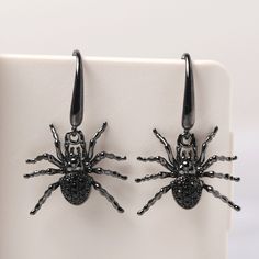 This is a spider earrings with black spinel, Sterling Silver Stud Earrings, Halloween Earrings, Animal Jewelry Cute and affordable earrings quirky and fun. The perfect gift for you or a friend or family member This unique spider earrings will bring a perfect touch of flair to your outfit. All HANDMADE ITEMS SHIP IN APPROX 8 DAYS Main Stone: Natural black spinel Main Stone Size: Round cut 1.3 x 1.3 mm (6) and 1.5x 1.5 mm(14) Main Stone Weight: 1.064 carat Side Stone: None Material: 925 Sterling S Spinel Earrings, Earrings Gothic, Spider Earrings, Black Earrings Dangle, Earrings Halloween, Halloween Earrings, Black Spinel, Drop Dangle Earrings, Halloween Jewelry