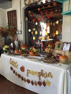 there is a table that has some food on it and fall decorations around the table