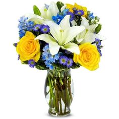 a vase filled with yellow roses and white lilies