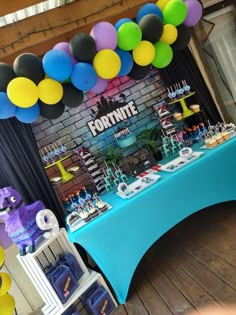 a table topped with lots of cake and balloons