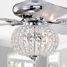 a ceiling fan with crystal balls hanging from it's blades