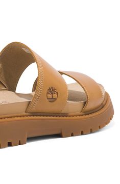 Crafted with responsibly sourced leather, this two-strap slide sandal offers walkable comfort with OrthoLite® cushioning, a faux-suede lining and a lug sole. 1 1/2" heel OrthoLite footbed Leather upper/textile lining/rubber sole Imported Timberland Leather Sandals With Removable Insole, Timberland Leather Open Toe Sandals, Timberland Leather Sandals With Cushioned Footbed, Timberland Synthetic Sandals For Spring, Timberland Synthetic Sandals With Removable Insole, Timberland Summer Sandals With Cushioned Footbed, Casual Leather Timberland Sandals, Timberland Sandals For Summer Beach, Timberland Open Toe Beach Sandals