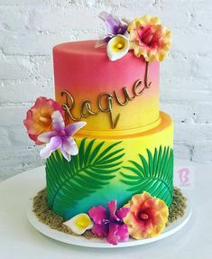 a multi - colored cake with flowers and the word rappel on top is sitting on a plate