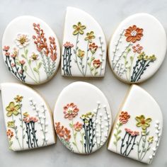 six decorated cookies with flowers on them