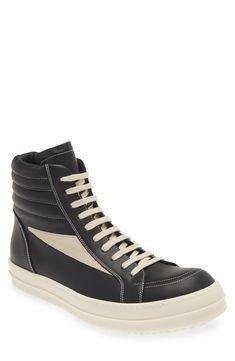 Crafted from full-grain leather and suede, this high-top sneaker is quintessentially Rick Owens with its blunted toe, dramatic lacing and shark-tooth sole. Drawing inspiration from vintage silhouettes and color schemes, this boldly topstitched shoe blends modern comfort with a timeless aesthetic. Lace-up style Leather upper and lining/rubber sole Made in Italy Designer Shoes White High-top Sneakers With Rubber Sole, White Sole High-top Sneakers With Rubber Sole, High-top Sneakers With Leather Sole, Leather High-top Sneakers With Vulcanized Sole For Streetwear, Leather High-top Boots With Vulcanized Sole, Leather High-top Sneakers With Rubber Sole For Streetwear, Modern Black High-top Sneakers With Gum Sole, High-top Leather Sneakers With Gum Sole, Urban Leather High-top Sneakers With White Sole