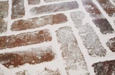 a close up of some type of tile on the ground with snow all over it