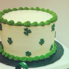 there is a cake with green decorations on the top and bottom layer that says st patrick's day