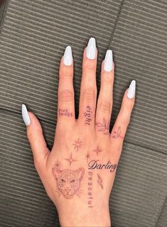 a woman's hand with tattoos on it