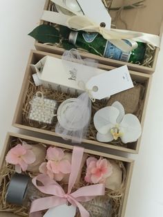 three boxes with flowers, soaps and other items in them