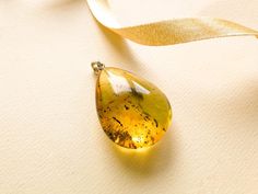 "SUBSCRIBE and get 10% OFF! http://eepurl.com/glhv05 After you have subscribed, please contact us at amber@torvela.com for the discount code. Natural Baltic amber green color pendant shaped in a thick drop form goes perfectly with every outfit! Perfect choice to brighten up office outfit or look even more beautiful on a special occassion! MATERIALS AND SIZE: Stone: 100% Natural Baltic Amber Other materials: silver 925 Weight: 8,5g (0.29 oz) Pendant size: 3,5cm (1,37 in) x 2,7 cm (1,06in) Total l Formal Yellow Teardrop Pendant Jewelry, Elegant Handmade Teardrop Pendant Drop, Yellow Teardrop Necklace For Formal Occasions, Yellow Teardrop Necklace For Formal Events, Formal Yellow Teardrop Necklace, Handmade Baltic Amber Teardrop Jewelry, Baltic Amber Drop Jewelry As Gift, Baltic Amber Drop Jewelry For Gifts, Pear-shaped Yellow Necklace For Gift