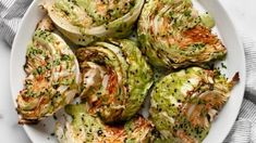 a white plate topped with brussel sprouts on top of a table