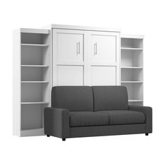 a gray couch sitting next to a white bookcase